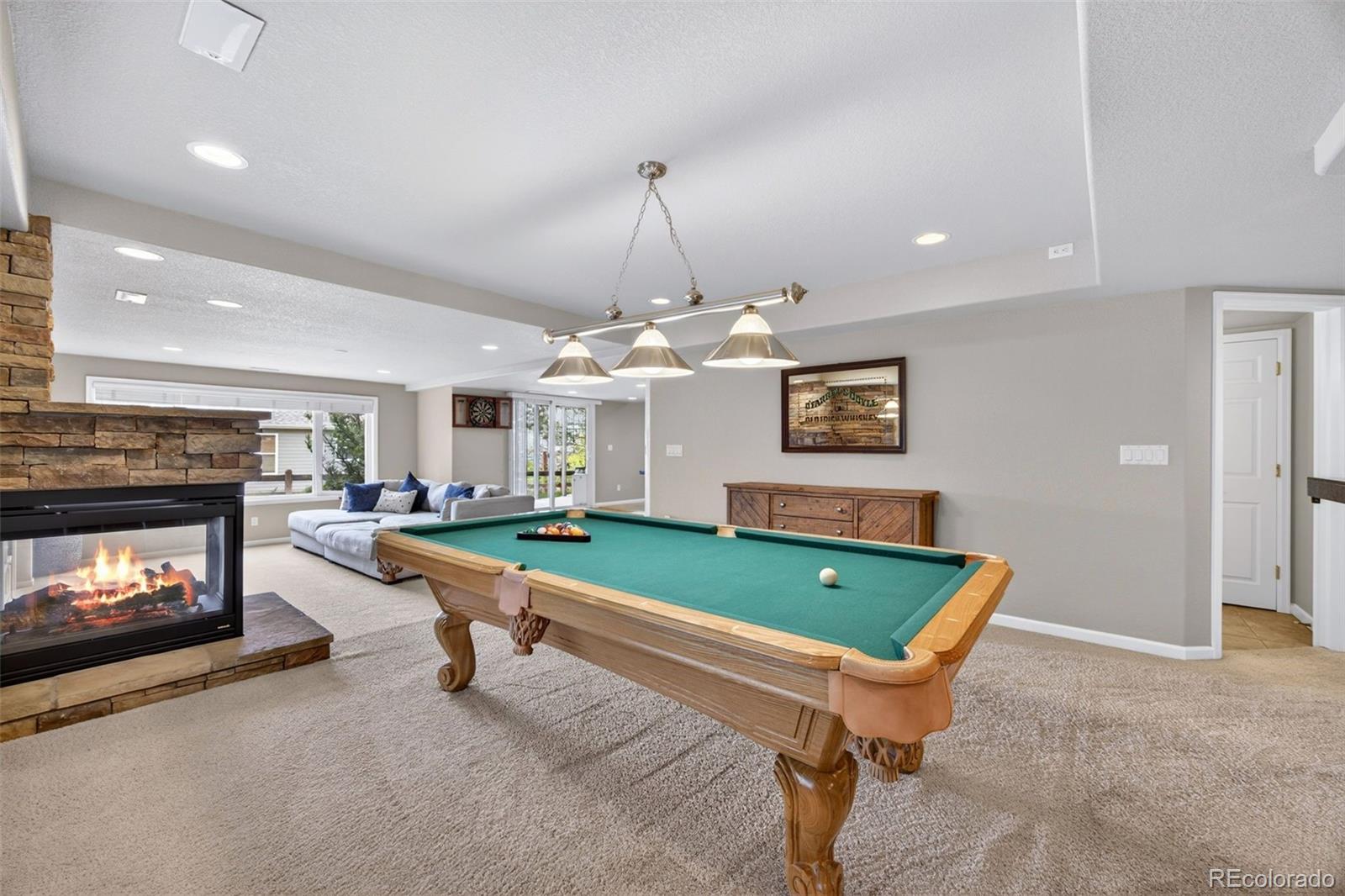 551 Seth Place Castle Pines, CO 80108 - Photo 34 of 50 a room with fireplace and pool table