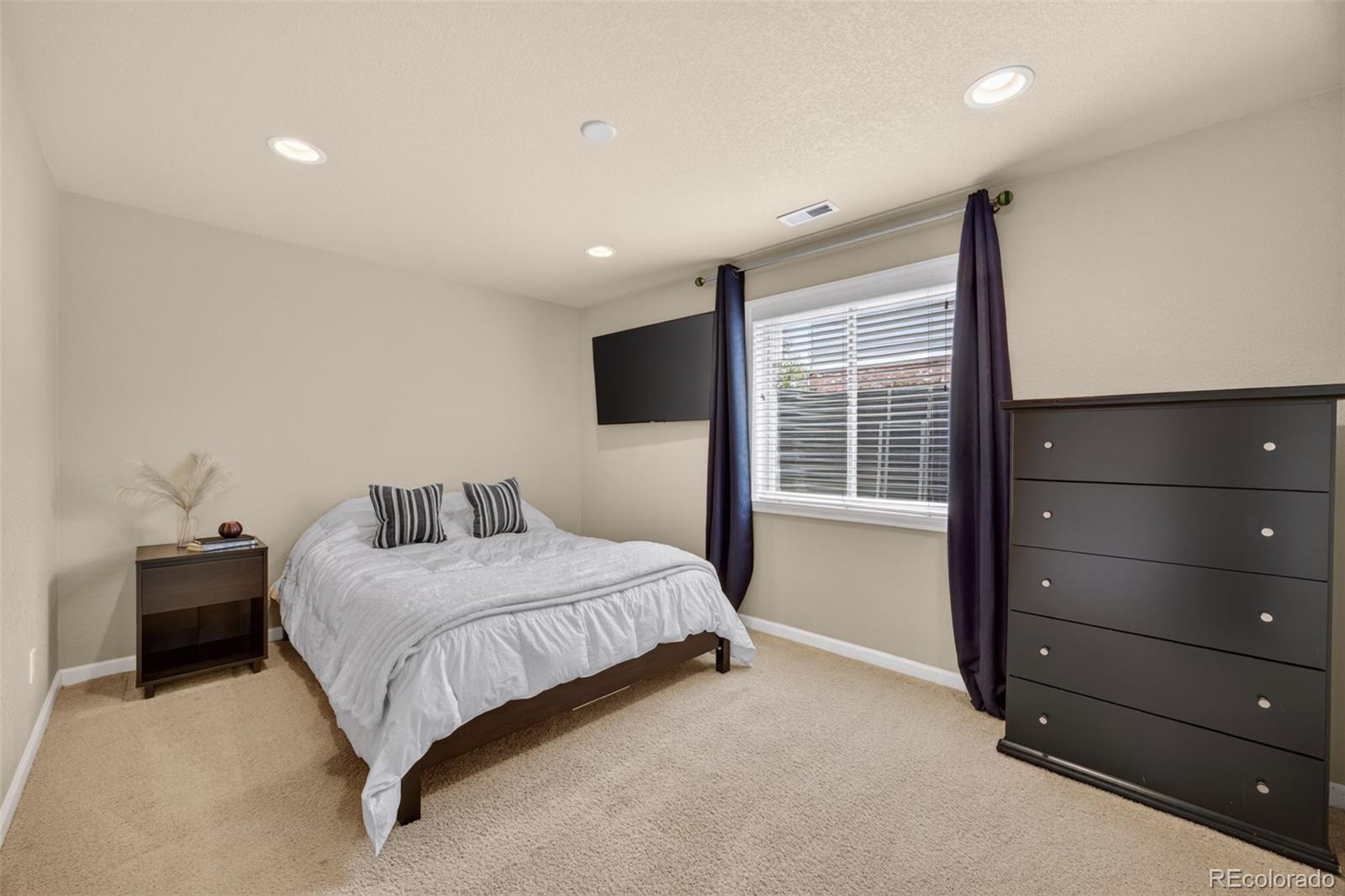 551 Seth Place Castle Pines, CO 80108 - Photo 38 of 50 a bedroom with a bed and a window