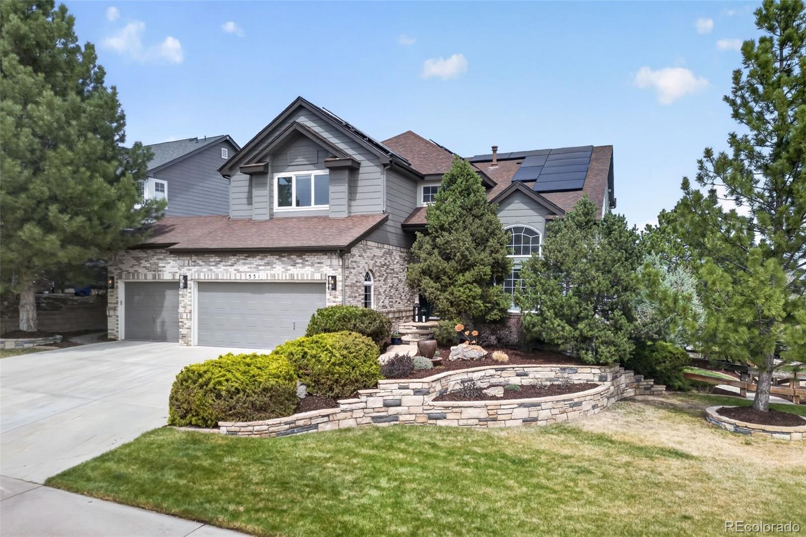 551 Seth Place Castle Pines, CO 80108 - Photo 45 of 50 a view of a house with a small yard and plants