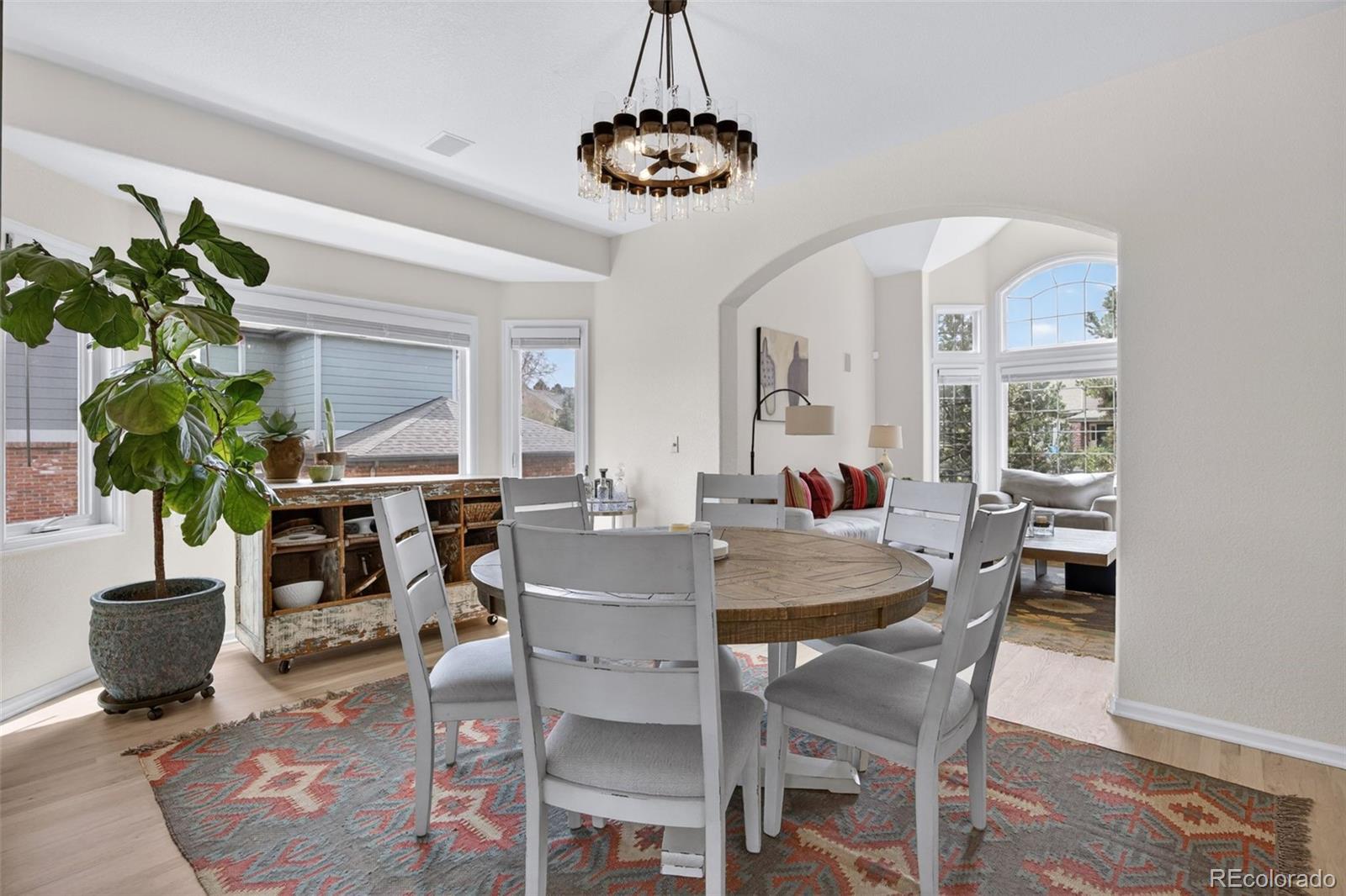 551 Seth Place Castle Pines, CO 80108 - Photo 5 of 50 a view of a dining room with furniture window and wooden floor