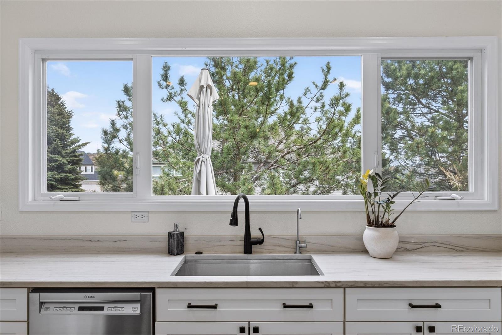 551 Seth Place Castle Pines, CO 80108 - Photo 9 of 50 a sink with garden view
