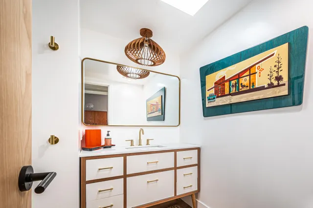 a bathroom with a toilet sink and mirror