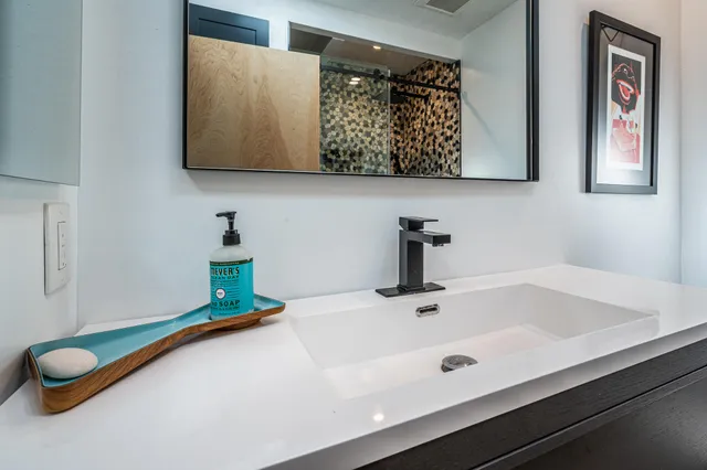 a living room with furniture and a mirror