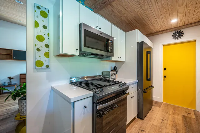 a bedroom with a bed and a potted plant