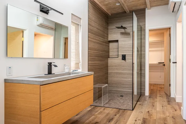 a view of a wooden bench with chairs in the garden