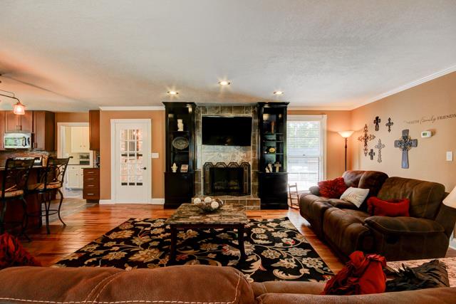 486 Cambridge Road Clarksville, TN 37043 - Photo 4 of 19 Custom tiled fireplace with built in shelving on either side.