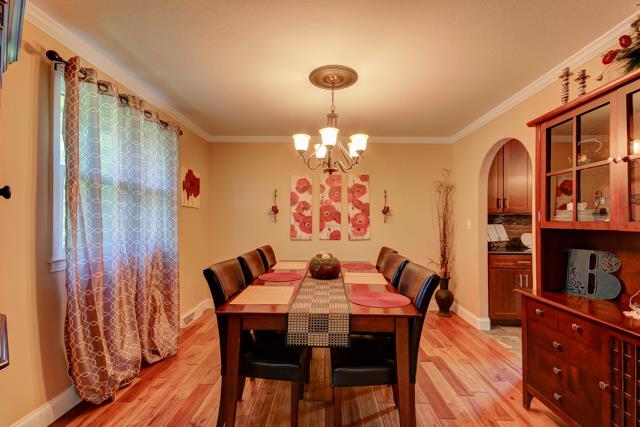 486 Cambridge Road Clarksville, TN 37043 - Photo 5 of 19 Arched door dining room with hardwood floors.