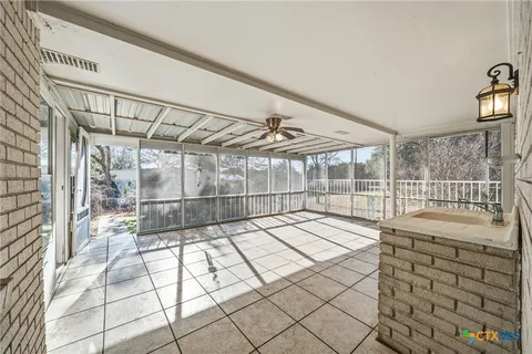 a view of a roof deck with wooden fence and floor