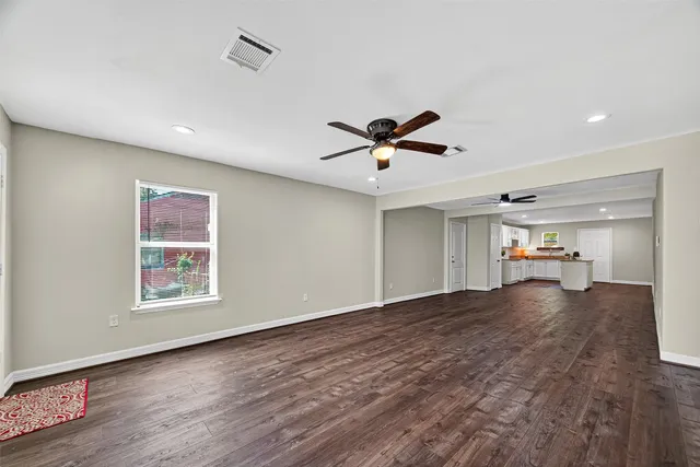 a view of a livingroom with a ceiling fan and wooden floor