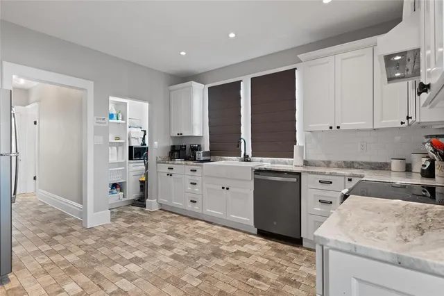a view of kitchen with refrigerator and window