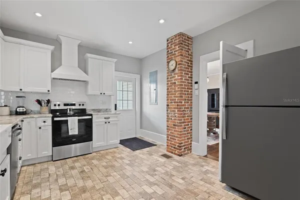 a bathroom with a sink a toilet a mirror and shower