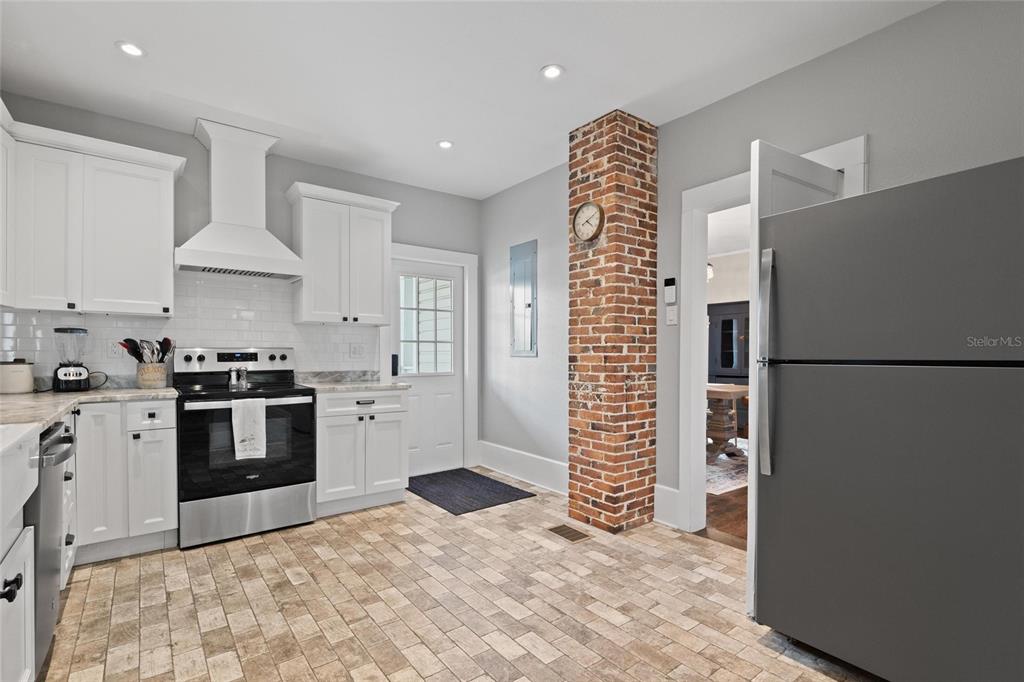 4 West Orange Street Tarpon Springs, FL 34689 - Photo 17 of 39 a kitchen with granite countertop a refrigerator stove and cabinets