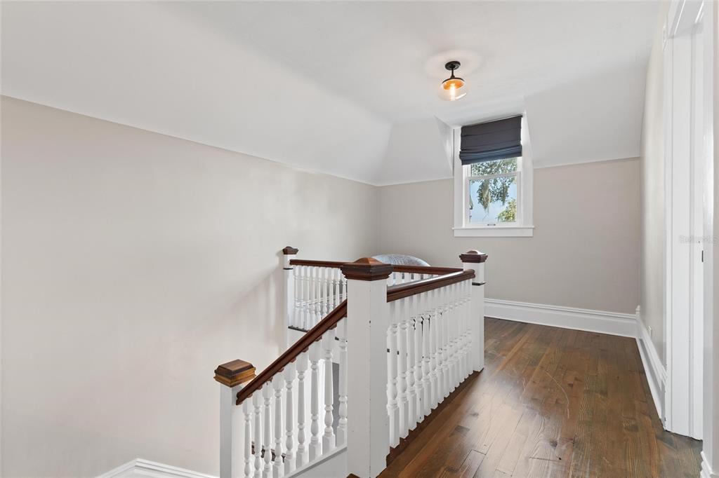 4 West Orange Street Tarpon Springs, FL 34689 - Photo 22 of 39 a view of a hallway with wooden floor and white walls