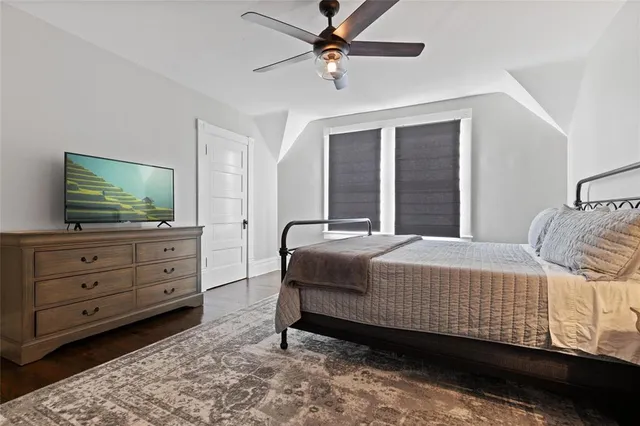 a bedroom with two beds and a chandelier