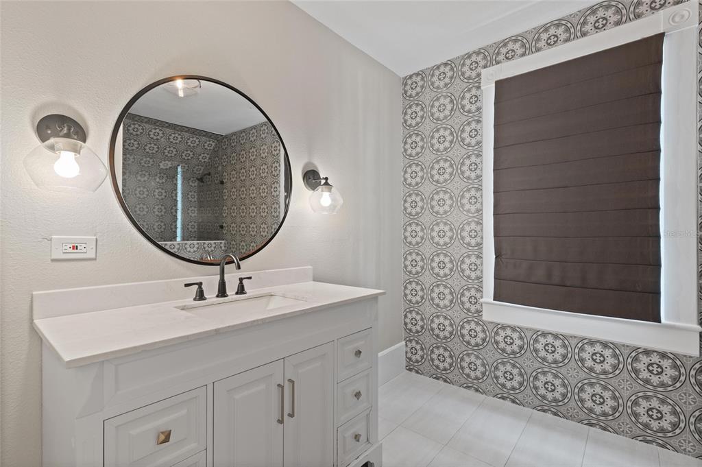 4 West Orange Street Tarpon Springs, FL 34689 - Photo 29 of 39 a bathroom with a sink and a mirror