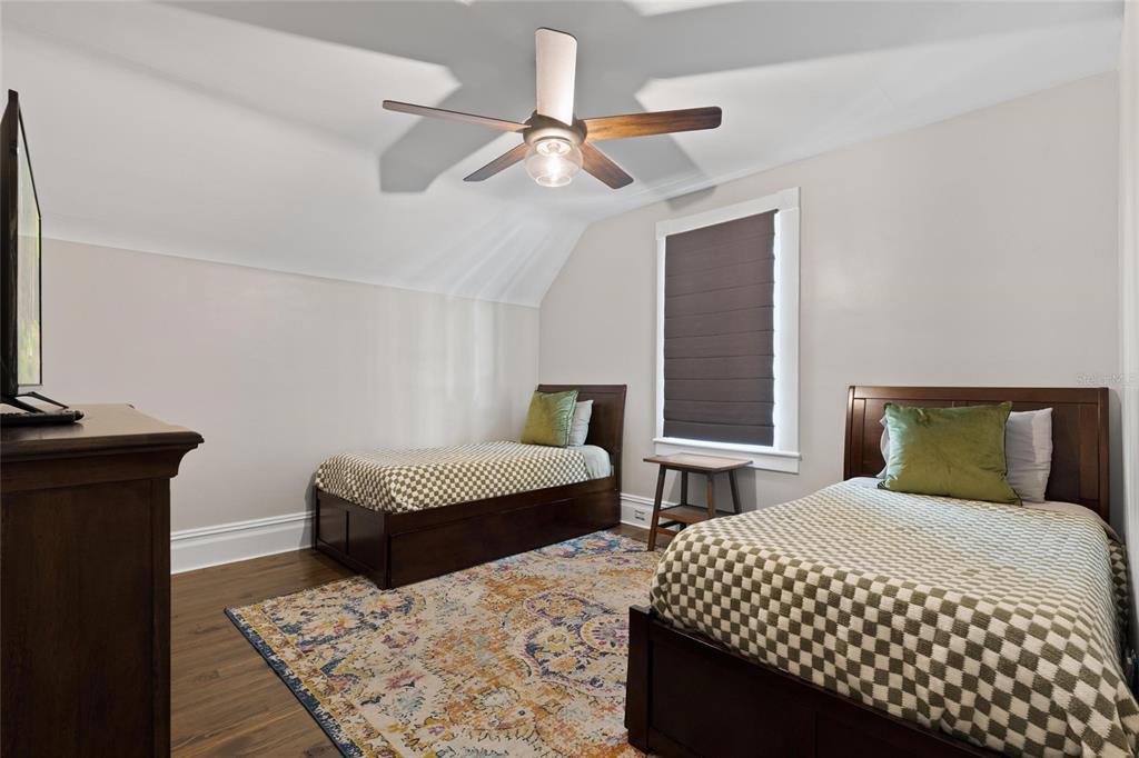 4 West Orange Street Tarpon Springs, FL 34689 - Photo 31 of 39 a bedroom with two beds and a chandelier