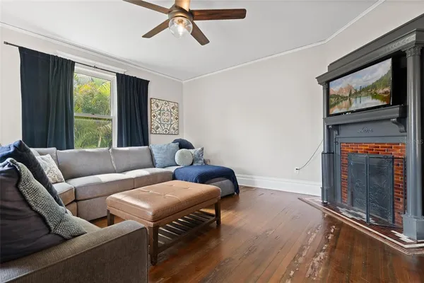 a living room with furniture a flat screen tv and a fireplace