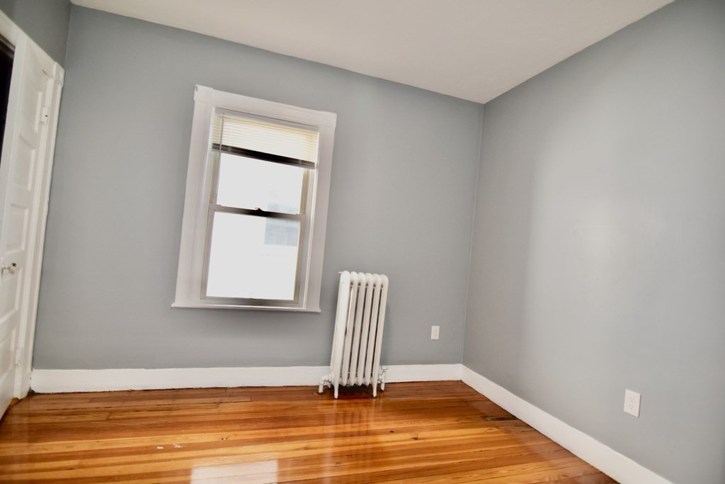 21 Treadway Road, Unit 2 Boston, MA 02125 - Photo 14 of 21 a view of room with wooden floor and chair