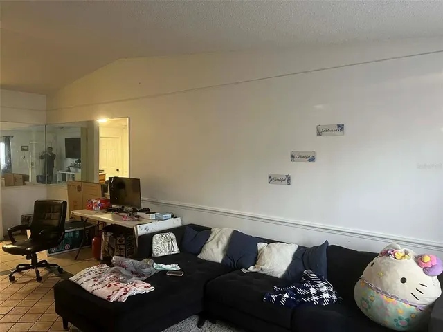 a living room with furniture and a mirror