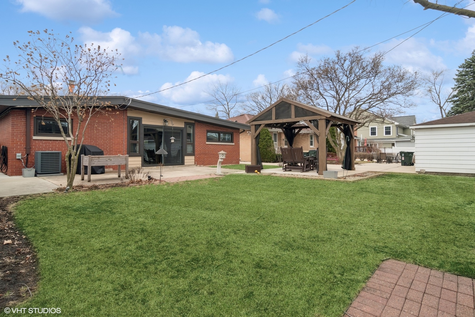 1505 Good Avenue Park Ridge, IL 60068 - Photo 18 of 19 a front view of a house with a garden and trees