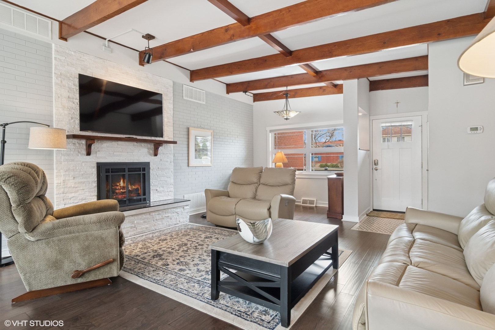1505 Good Avenue Park Ridge, IL 60068 - Photo 2 of 19 a living room with furniture a flat screen tv and a fireplace