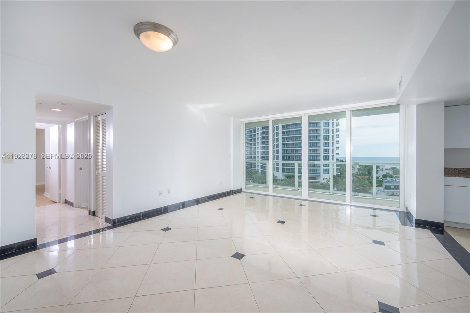 5900 Collins Avenue, Unit 906 Miami Beach, FL 33140 - Photo 14 of 49 a view of an empty room with a window