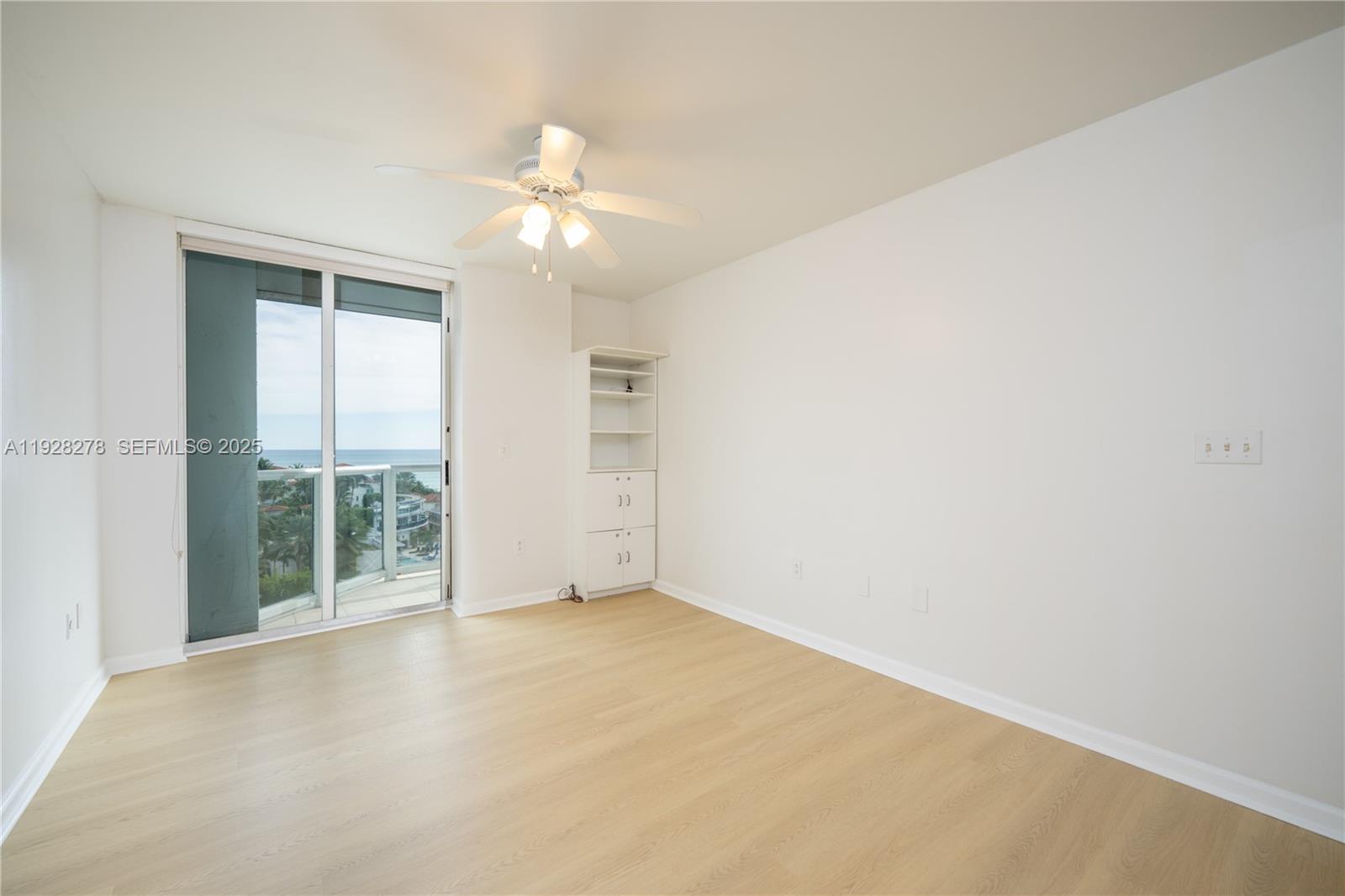 5900 Collins Avenue, Unit 906 Miami Beach, FL 33140 - Photo 21 of 49 an empty room with chandelier fan