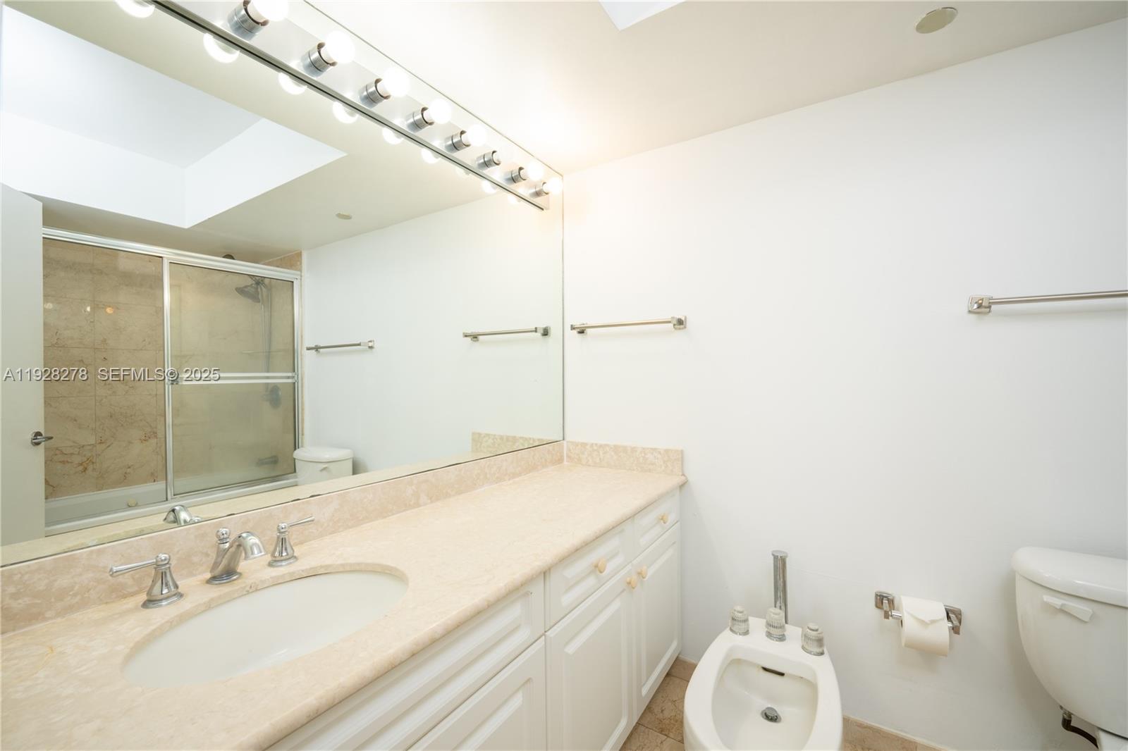 5900 Collins Avenue, Unit 906 Miami Beach, FL 33140 - Photo 25 of 49 a bathroom with a sink and a mirror