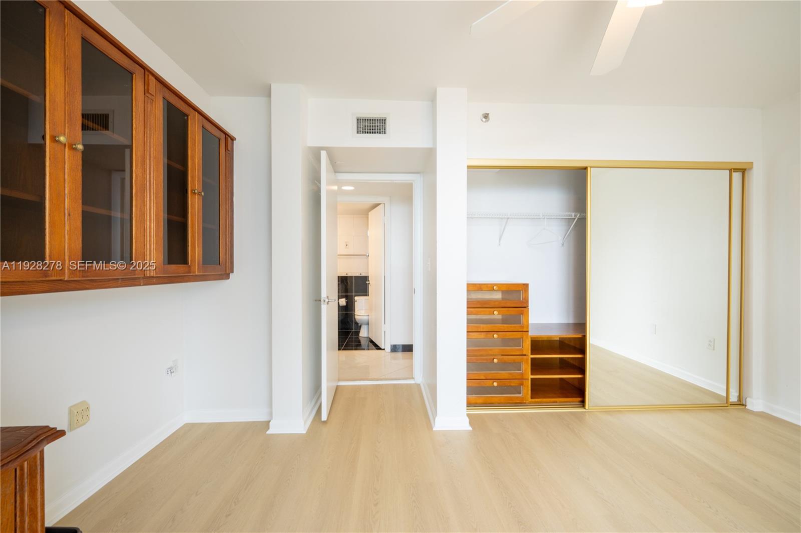 5900 Collins Avenue, Unit 906 Miami Beach, FL 33140 - Photo 27 of 49 a view of an empty room with wooden floor and a window