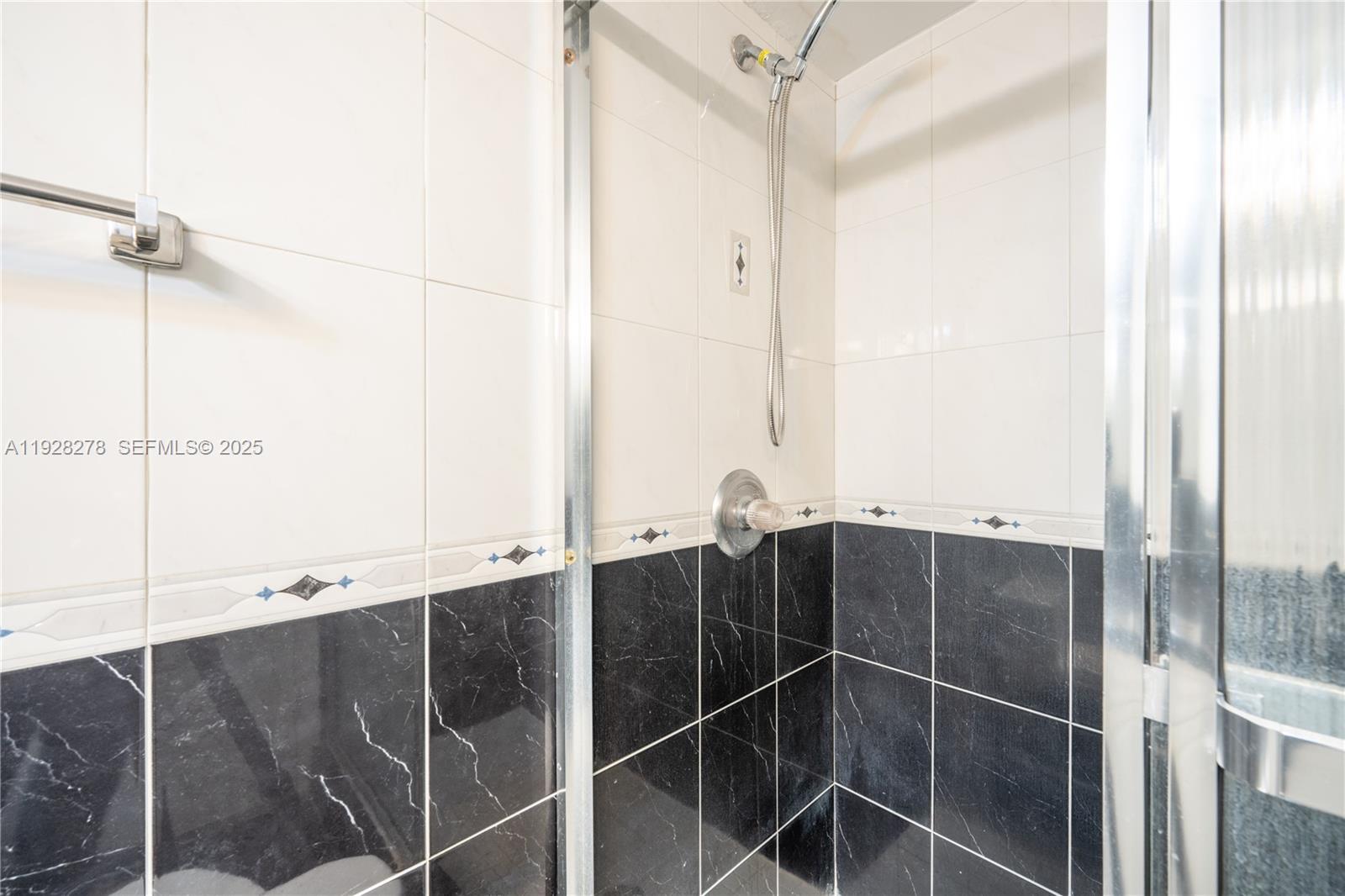 5900 Collins Avenue, Unit 906 Miami Beach, FL 33140 - Photo 31 of 49 a bathroom with a shower and a sink