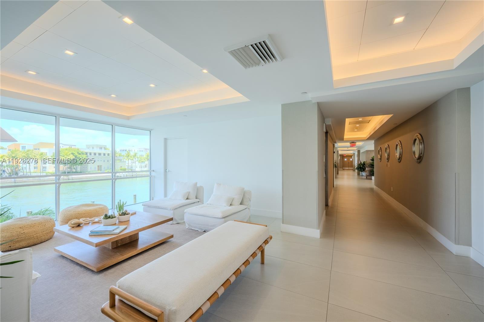 5900 Collins Avenue, Unit 906 Miami Beach, FL 33140 - Photo 39 of 49 a living room with furniture and a floor to ceiling window