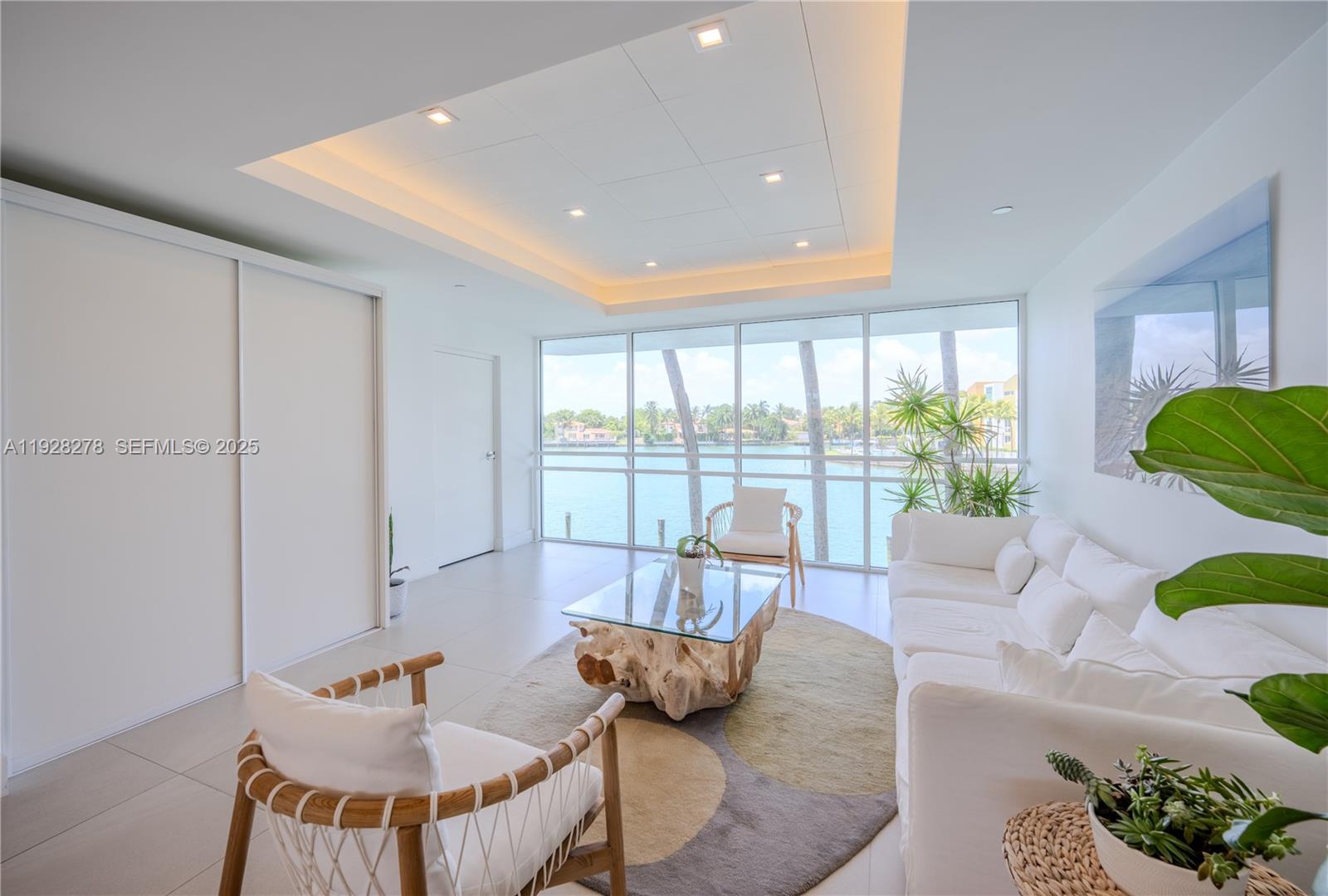 5900 Collins Avenue, Unit 906 Miami Beach, FL 33140 - Photo 40 of 49 a living room with furniture and a large window