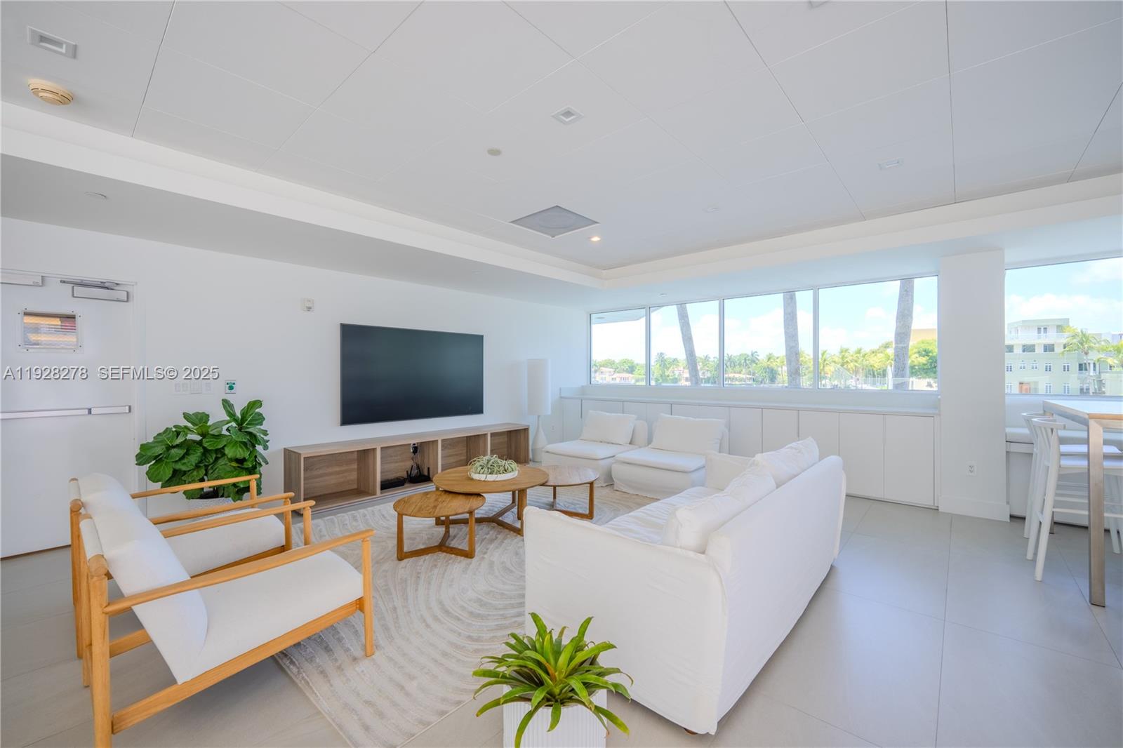 5900 Collins Avenue, Unit 906 Miami Beach, FL 33140 - Photo 43 of 49 a living room with furniture and a flat screen tv