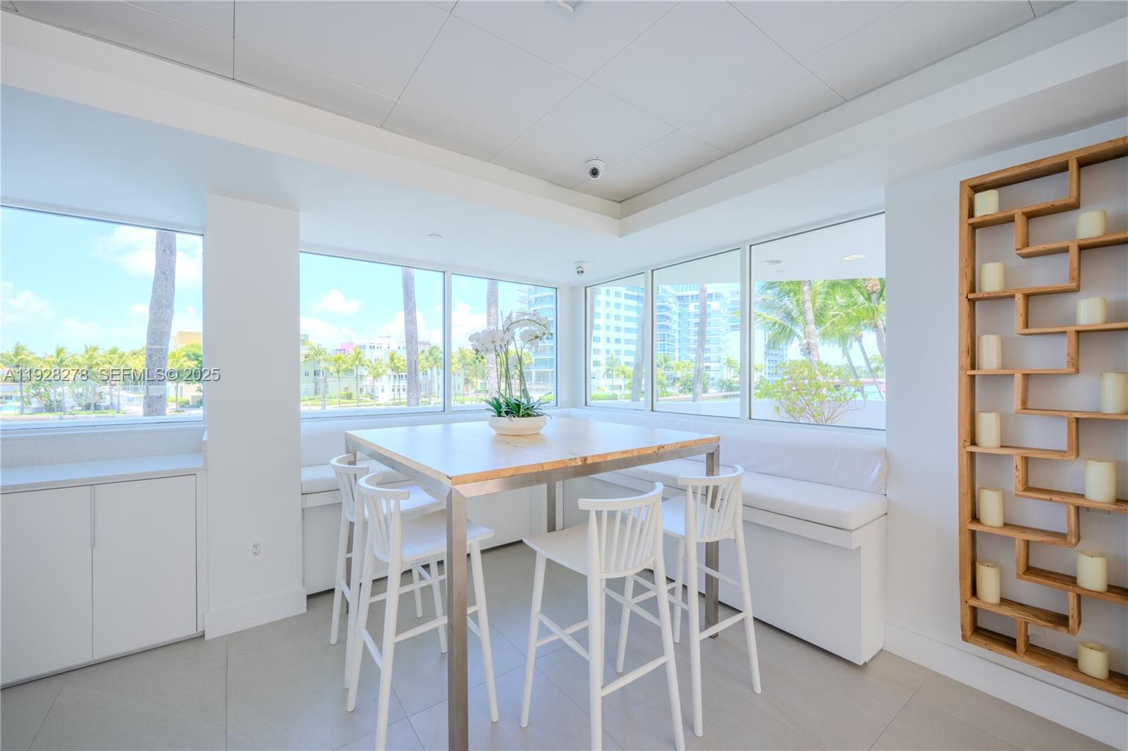 5900 Collins Avenue, Unit 906 Miami Beach, FL 33140 - Photo 44 of 49 a view of a kitchen with a table and chairs