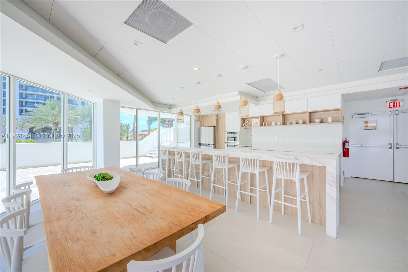 5900 Collins Avenue, Unit 906 Miami Beach, FL 33140 - Photo 45 of 49 a living room with furniture a table and chairs