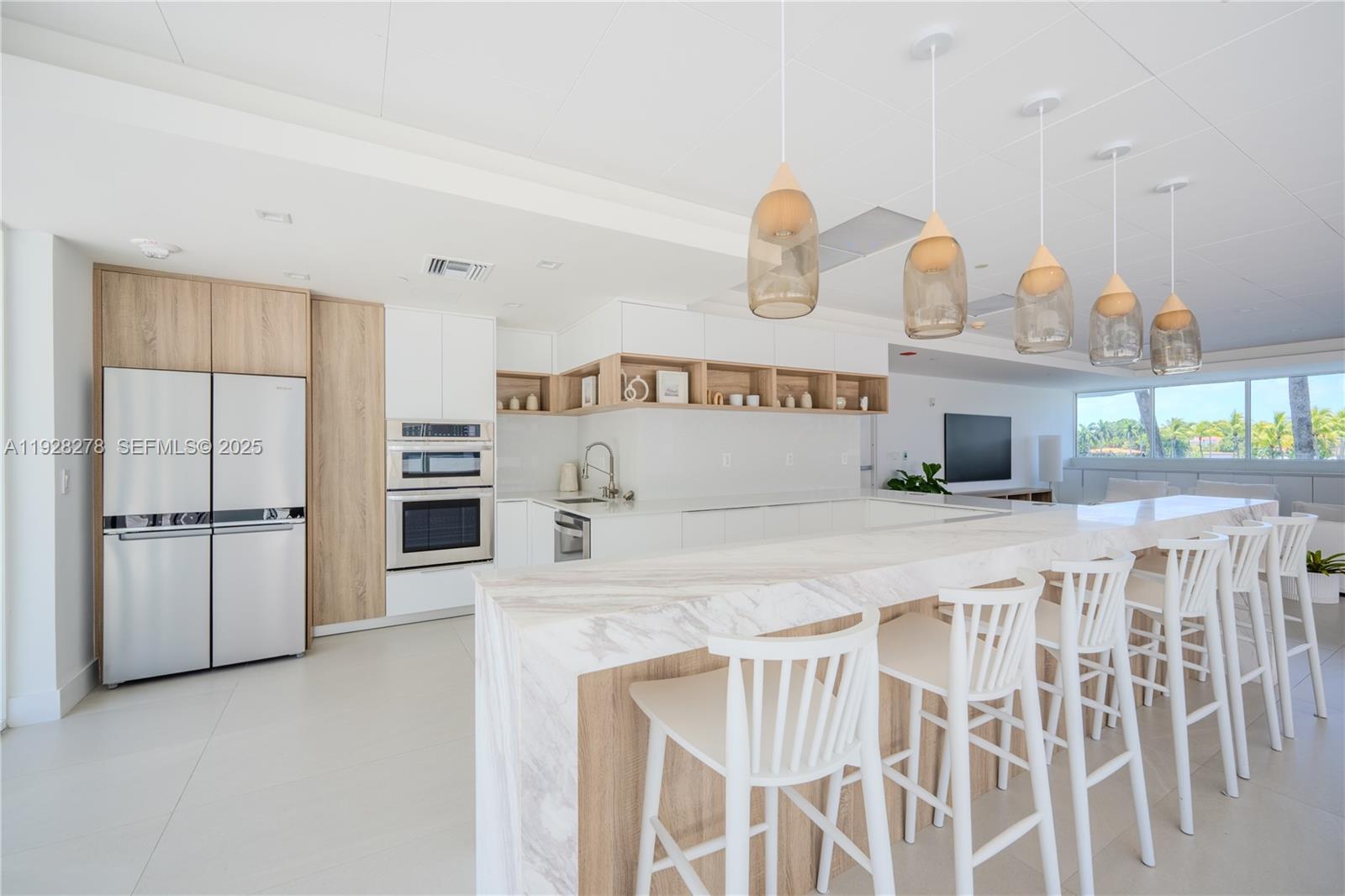 5900 Collins Avenue, Unit 906 Miami Beach, FL 33140 - Photo 46 of 49 a kitchen with kitchen island and a sink