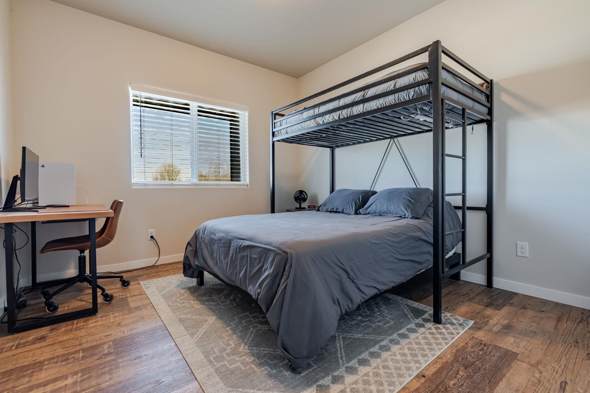 1301 M Road Loma, CO 81524 - Photo 25 of 32 a bedroom with a bed a table and chair