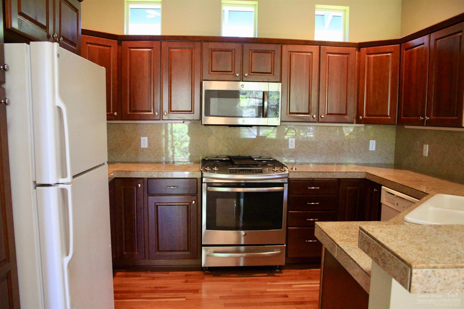 19459 Blue Lake Loop Bend, OR 97702 - Photo 10 of 19 a kitchen with stainless steel appliances granite countertop a refrigerator stove and microwave