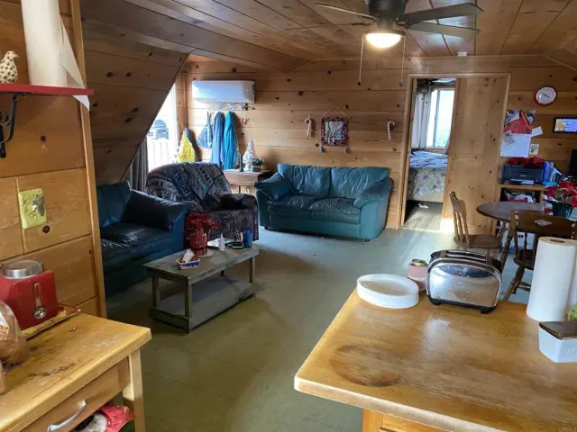 a living room with furniture a dining table and kitchen view