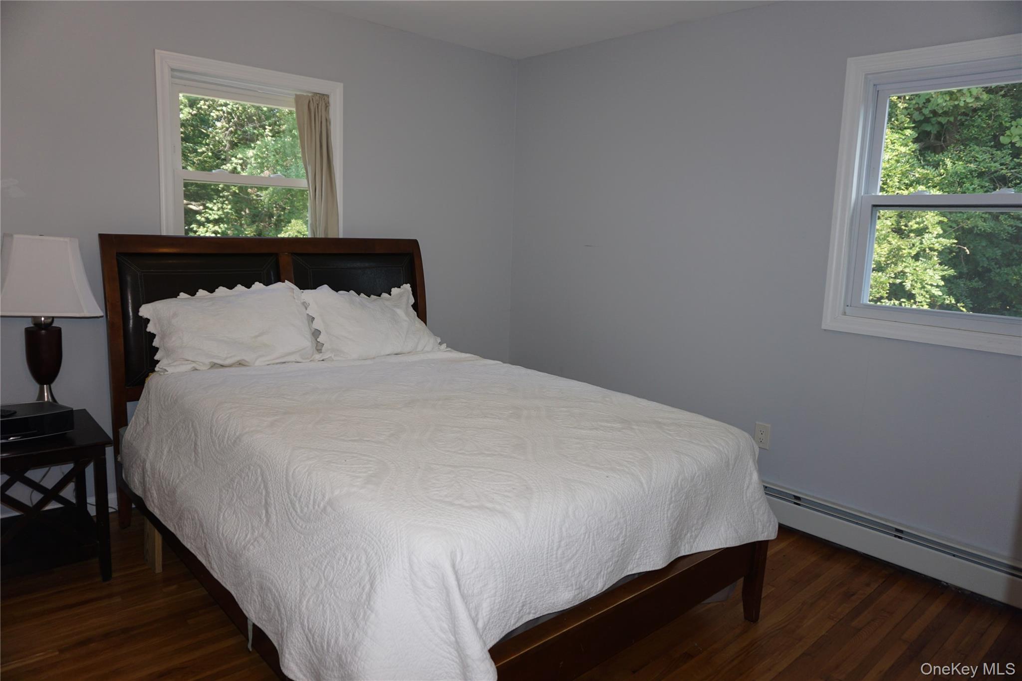 15 Greenridge Way Spring Valley, NY 10977 - Photo 13 of 17 Bedroom with dark wood finished floors and baseboard heating