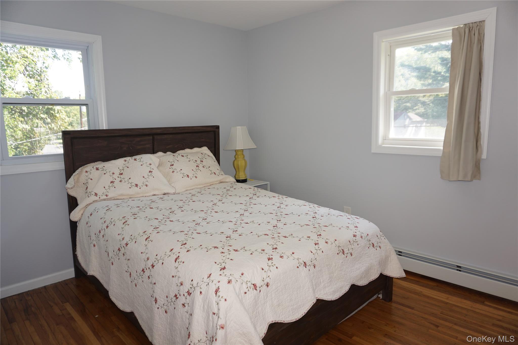 15 Greenridge Way Spring Valley, NY 10977 - Photo 14 of 17 Bedroom with dark wood-type flooring and a baseboard heating unit