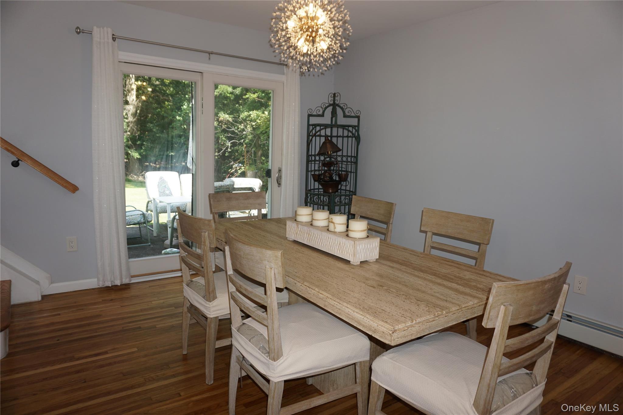 15 Greenridge Way Spring Valley, NY 10977 - Photo 7 of 17 Dining room featuring a chandelier, stairway, and dark wood-style floors