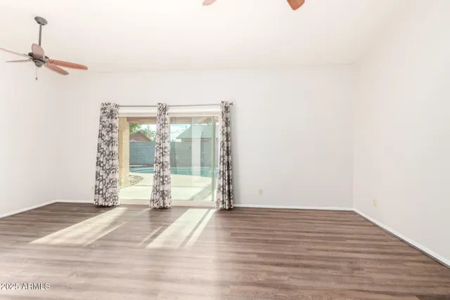 a floor to ceiling window with wooden floor