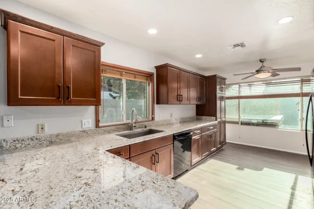 a large kitchen with stainless steel appliances granite countertop a sink and a stove