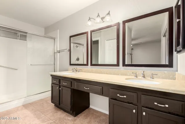 a bathroom with a double vanity sink and mirror