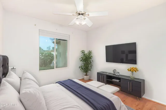 a bedroom with a bed and a flat screen tv