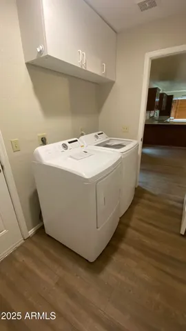 a view of a room with wooden floor