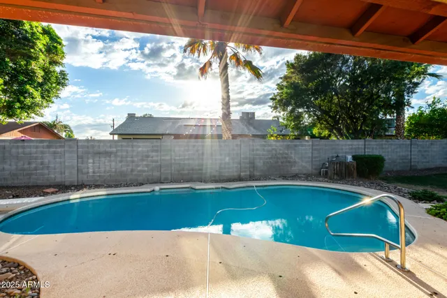 a view of a backyard with a swimming pool