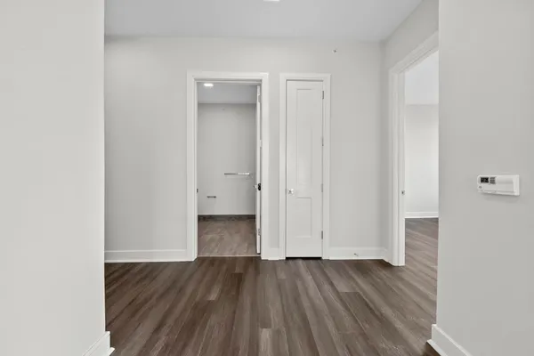 a view of an empty room and wooden floor
