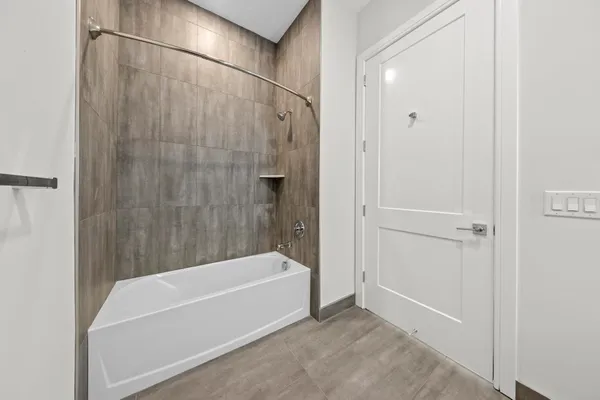 a bathroom with a bathtub and a shower